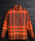 Orange and black patterned jacket on a wooden hanger against a dark wooden background
