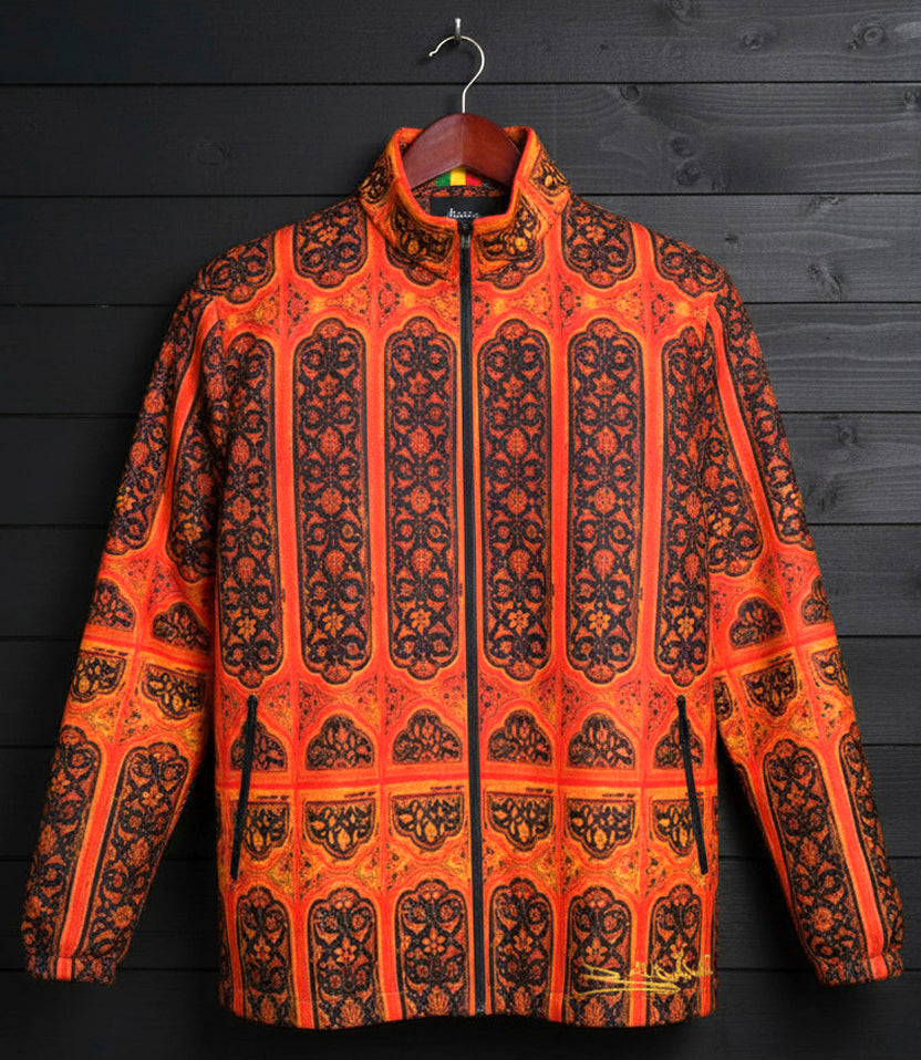 Orange and black patterned jacket on a wooden hanger against a dark wooden background